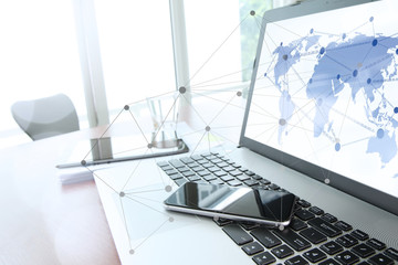 Office workplace with laptop computer and smart phone and stylus