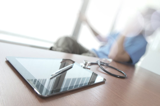 Doctor working with digital tabletr in medical workspace office