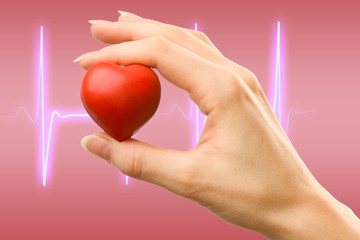 Female hand with red heart