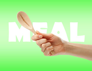 Wooden spoon in female hand