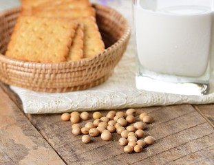 milk , soy beans and cracker on wood background