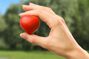 Female hand with red heart