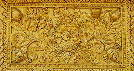 The gold stucco design of native thai style on the Wall