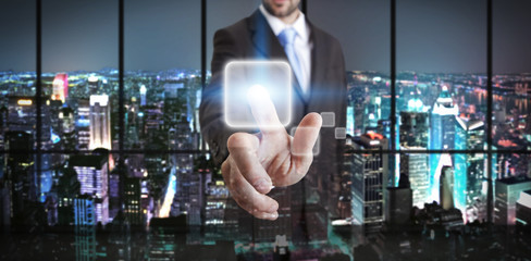 Fototapeta premium Businessman in his office using tactile interface