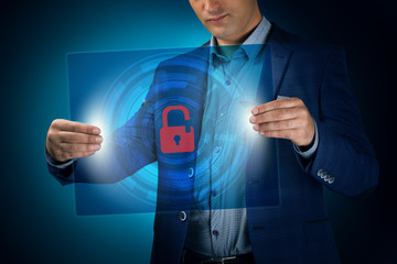 Businessman holding a transparent screen with an icon unlock. Bu
