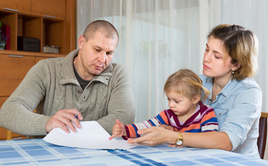 Worried family with financial documents