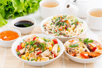 Asian food - fried rice with tofu, noodles with vegetables 