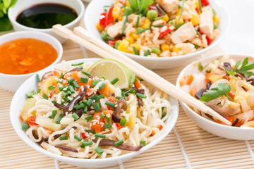 Asian food - noodles with vegetables and greens, fried rice 