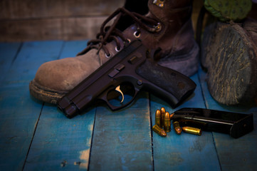 Still life whit group of Bullets ,Gun, and dirty Boots