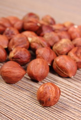 Heap of brown hazelnut on wooden table