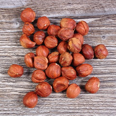Heap of brown hazelnut on wooden table
