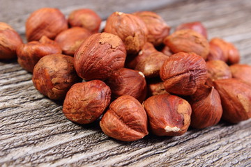 Heap of brown hazelnut on wooden table