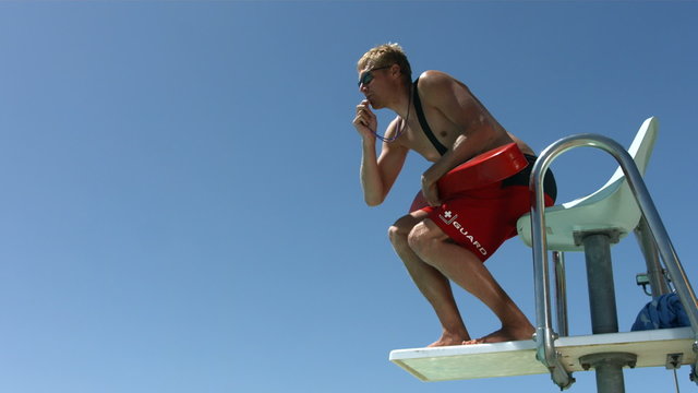 Life guard jumps from platform, slow motion
