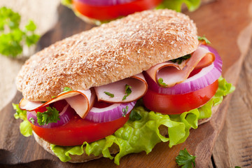 sandwich with ham tomato and lettuce