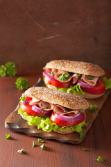 sandwich with ham tomato and lettuce