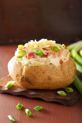 baked potato in jacket with bacon and cheese