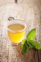 herbal sage tea with green leaf in glass cup