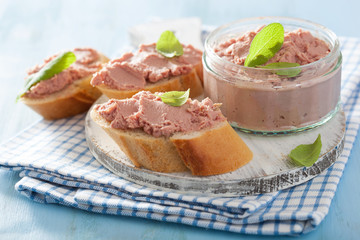 healthy chicken liver pate with sage in jar and on bread