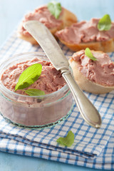 healthy chicken liver pate with sage in jar and on bread