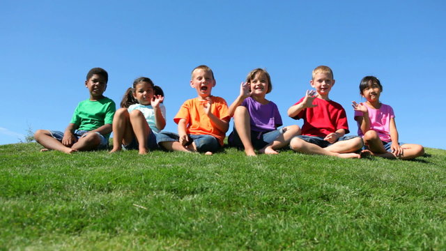 Portrait of children of various ethnicities on a hilltop 