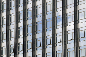 Clouds reflected in windows of modern office building
