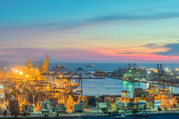 Container Cargo freight ship with working crane bridge in shipya