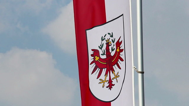 Flag with Tyrol coat of arms, popular Austrian tourism center