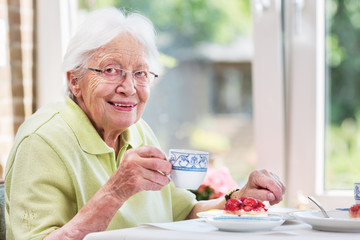 Elderly woman drinking coffee