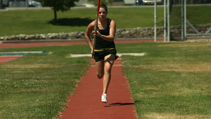 Athlete running with javelin, slow motion - Powered by Adobe