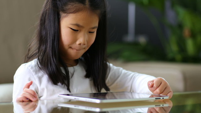 Young Asian girl using digital tablet