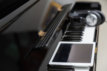 Tablet and head phones on Piano keys