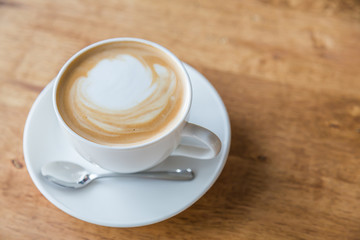 Coffee in white cup on wood table
