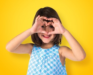 Girl making a heart with her hands