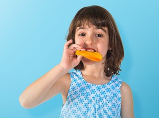 Girl eating an orange slice