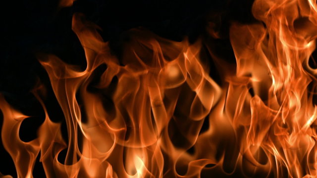 Closeup of flames burning on black background, slow motion