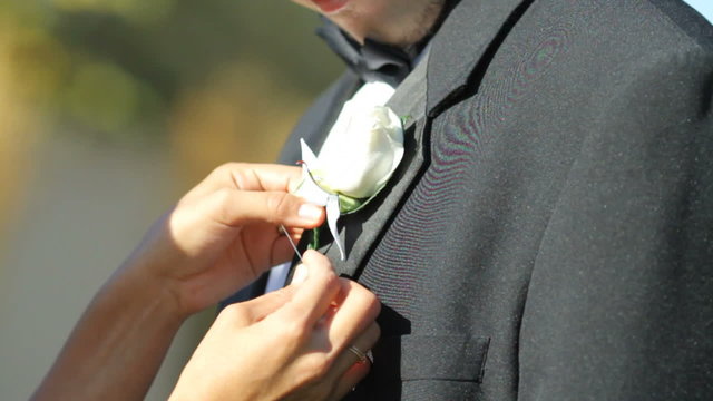 Putting white flower on lapel