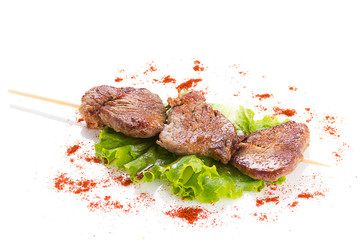 tasty grilled meat and vegetables on skewers, isolated on white on white background