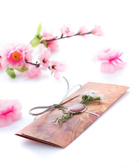 Hand made wedding invitation with flower decoration isolated on white