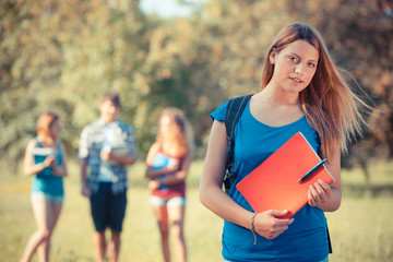 Young Female Student at Park with Other Friends