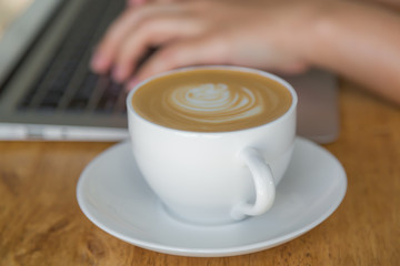 laptop with coffee cup on old wooden table ( Filtered image proc