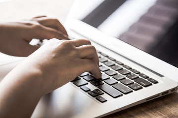 Closeup of business woman hand typing on laptop keyboard ( Filte