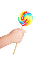 Child's hand holding lollipop candy