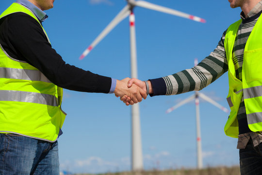 Engineers giving Handshake in a Wind Turbine Power Station