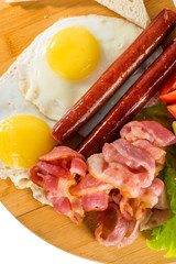 Toasts, fried egg, sausages, meat and vegetables
