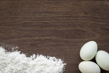 Baking background, eggs and flour on desk