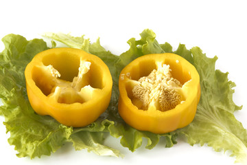 Cutted sweet yellow pepper on salad leaves