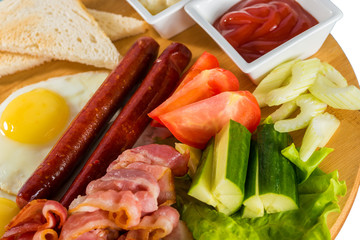 Toasts, fried egg, sausages, meat and vegetables

