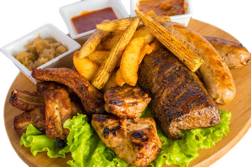 Roasted meat, sausages with corn and sauce
