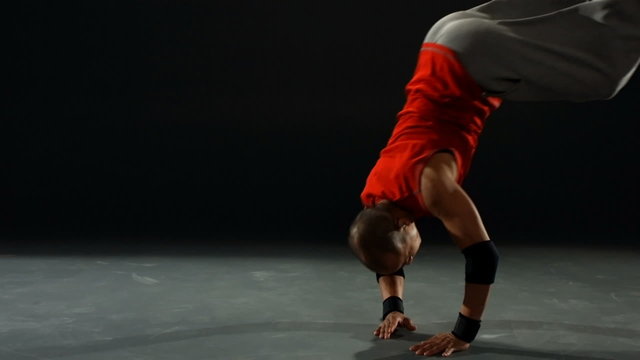 Breakdancer dives and rolls, slow motion