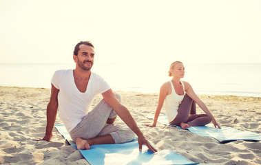 Fototapeta premium couple making yoga exercises outdoors